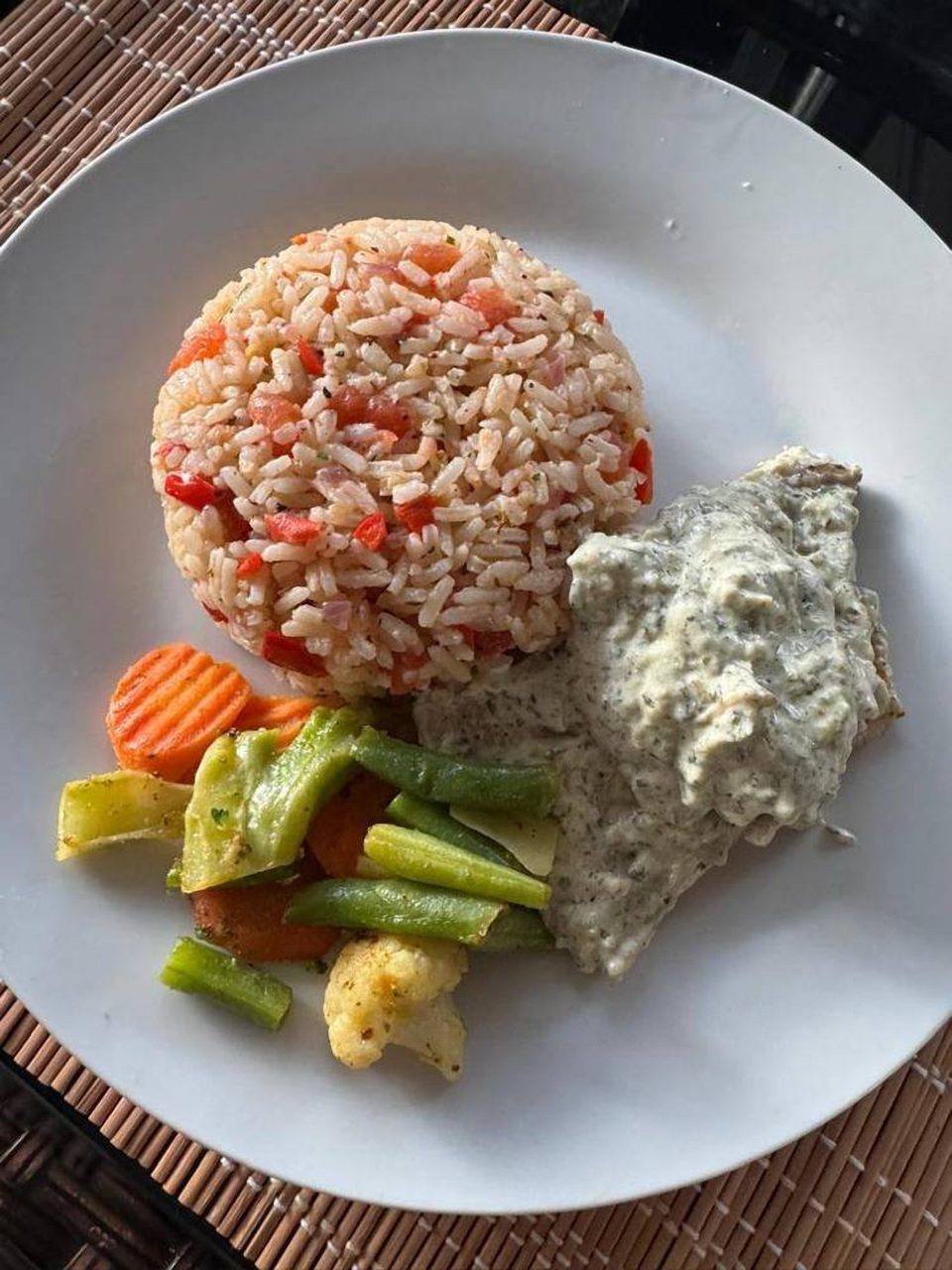 Fish with herb sauce and rice