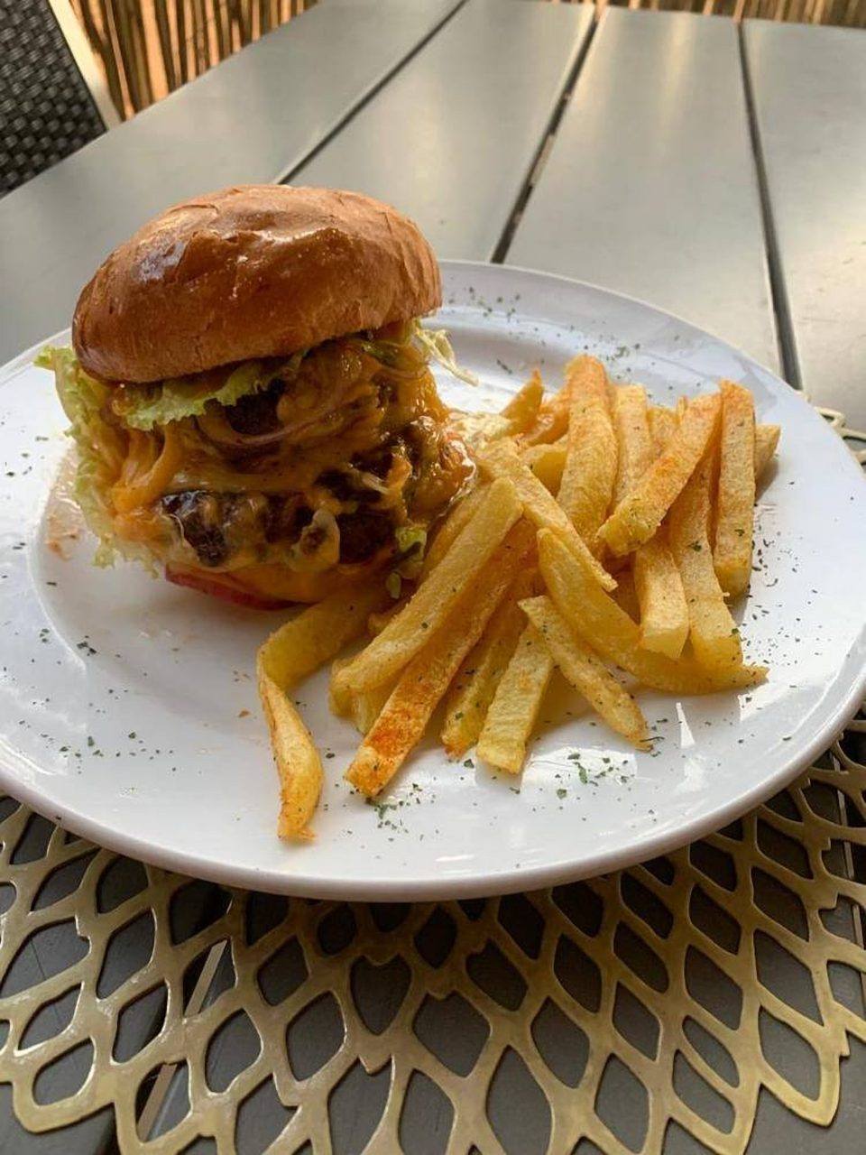 A loaded cheeseburger with chips