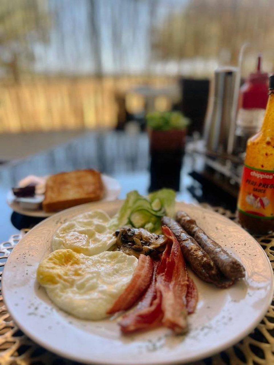 Full breakfast plate with eggs, bacon and sausage