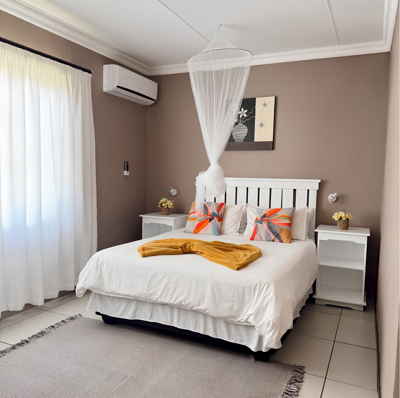 Double Room at Omateko Lodge, Gobabis, with double bed, mosquito net canopy and white furniture